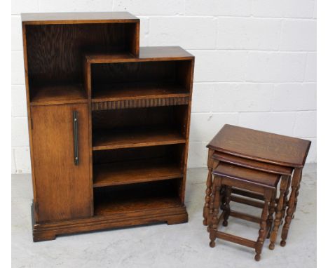 A c1930s oak graduated shelf bookcase, one cupboard door to side on plinth base, height 107cm and a nest of three oak tables 