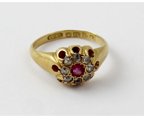 An 18ct gold ladies' dress ring, floral-set with central red stone and white stones, size G, approx 3.6g.