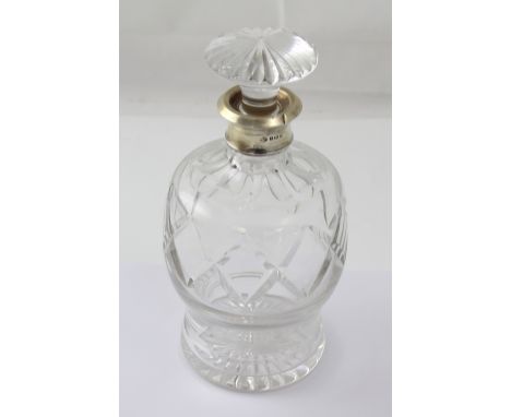 A cut glass decanter with a George V hallmarked silver collar, Adie Brothers, Birmingham 1933.