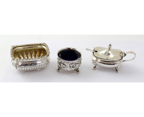 A Victorian hallmarked silver salt on scrolling supports, Mappin & Webb, London 1896, a George V hallmarked silver mustard an