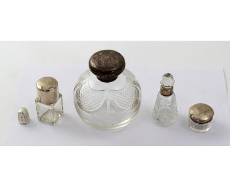 Three cut glass Edwardian perfume bottles to include one large ovoid example and one small square perfume bottle and a small 