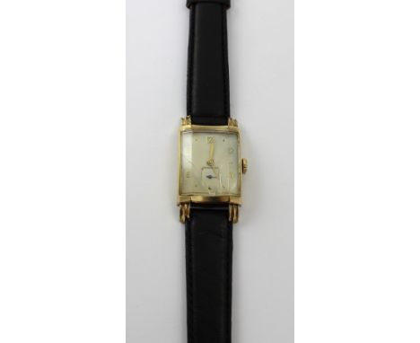 Longines; a 1960s gentlemen's tank style watch, gold filled case, the white painted dial with applied gold filled Arabic and 