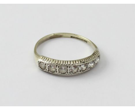 A 9ct white gold half eternity ring set with seven simulated diamonds, size N 1/2, approx 1.7g.