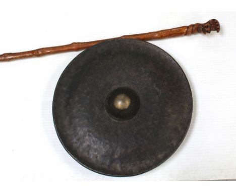 A vintage Indian dinner gong with domed centre, diameter 47.5cm, and an Indian carved walking cane with five headed hydra and
