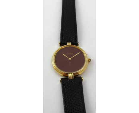 Cartier; a vintage gold-plated silver quartz wristwatch with burgundy dial, marked 'Must de Cartier', diameter 30mm.   CONDIT