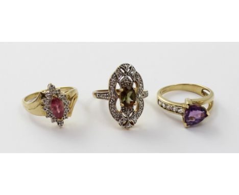 A 9ct gold amethyst and white topaz ladies' dress ring, size M 1/2, a 9ct gold ruby and diamond ladies' dress ring, size N an