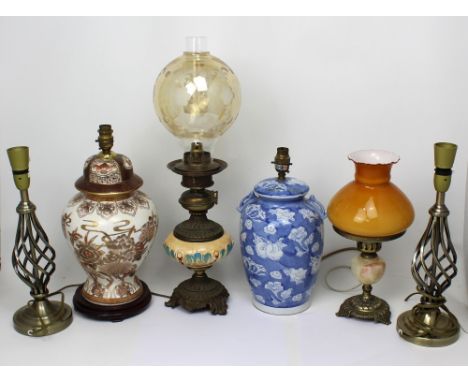 Six lamps to include a blue and white baluster Oriental-style example, an Oriental floral and gilt-heightened baluster lamp, 