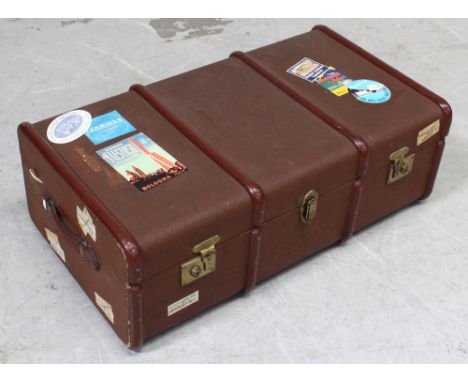 An early-to-mid 20th century travel trunk with various travel labels to include, Albergo, Maestoso, Bologna Italia, Den Haag,