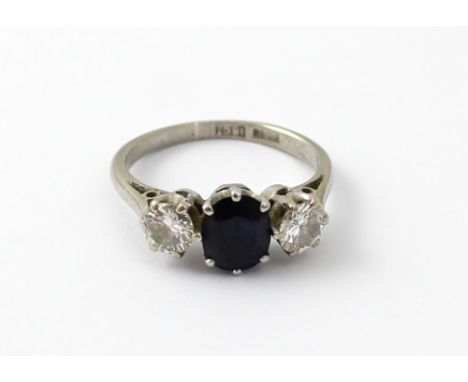 An 18ct white gold ladies' ring, central oval sapphire and diamond to either side, size J, approx 3.6g.