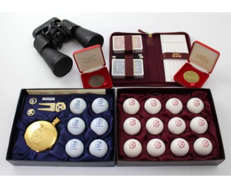 A boxed set of St Andrews antiquity golf balls, a gold-plated St Andrews hip flask, pin badges, divot and a boxed set of twel