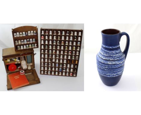 A quantity of ceramic and metal thimbles, a vintage first aid box and a West German single-handled blue ceramic vase, height 