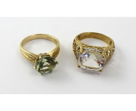 A 9cty gold 'Glacier Topaz' and diamond ring, size N and a 9ct gold green amethyst ladies' dress ring, size M 1/2, approx 8.5