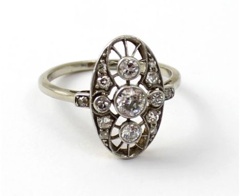 An Art Deco diamond-set platinum dress ring, set with 0.2ct central stone and with 0.5 stones above and below, within a chip 