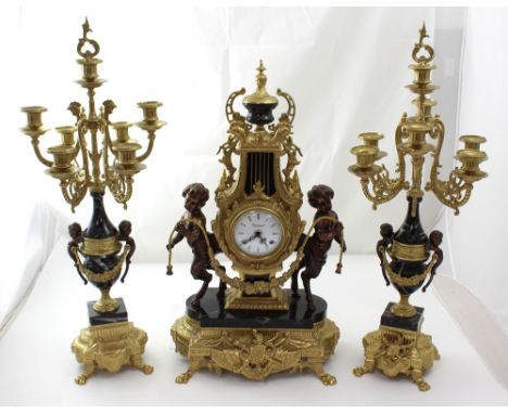 A Louis XVI style lyre-shaped clock and garniture, the clock in black marble, gilt brass and with young satyr figures flanked