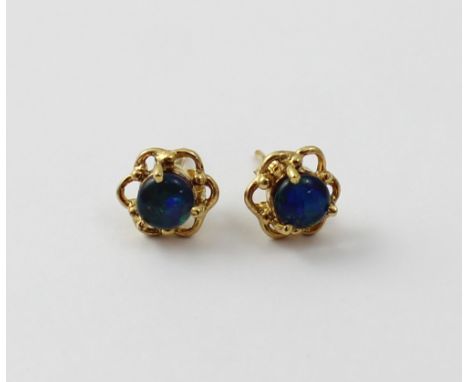 A pair of yellow metal wire work mounted black opal doublet stud earrings, in original box from Rochis Opal.