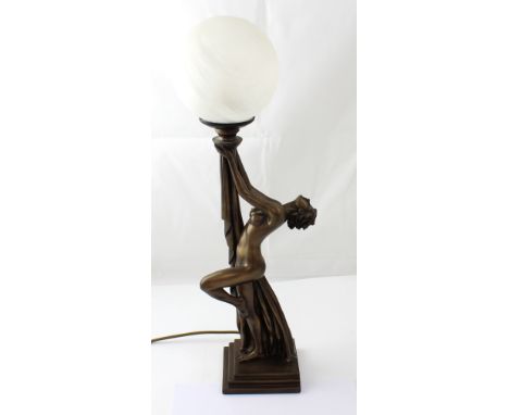 An Art Deco style lamp, naked dancing lady base supporting an opaque spherical glass shade, height 59cm.