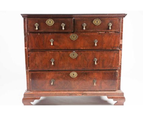 A William &amp; Mary figured walnut chest of Two short over Three long drawers. The crossbanded, quarter veneered top with ho