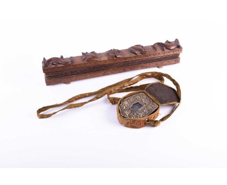 A Tibetan traveling Buddhist shrine, Gau, copper cased with a white metal embossed front with auspicious symbols framing a sh