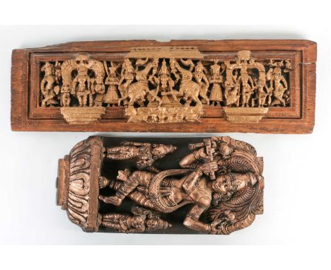 A  deeply carved, and gilt Indian hardwood panel of Lord Krishna playing the flute with two smaller attendants. 56cm x 28cm. 