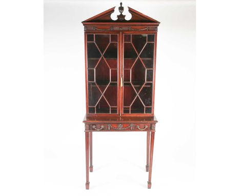 A Geo III style carved mahogany console bookcase, with 'broken arch and urn' pediment over a pair of astragal glazed doors, t