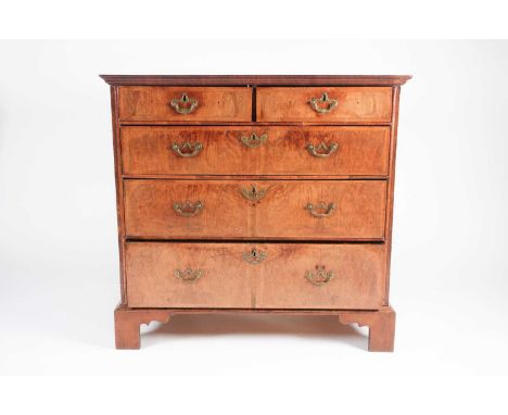 An early 18th century walnut chest of drawers with crossbanded quarter veneered above Two short over Three long, feather band