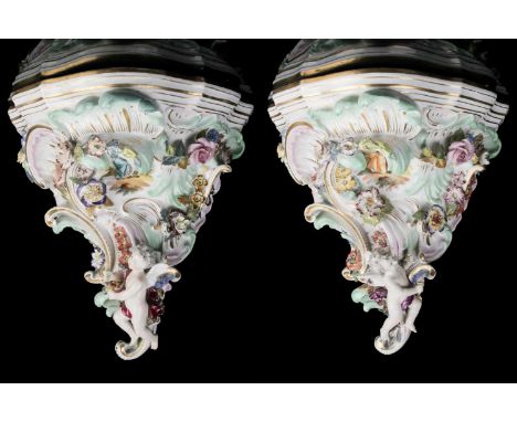 A pair of 19th c. Austrian, Vienna porcelain wall brackets with flower, scroll, and winged putto decoration and painted vigne