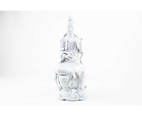 A large Chinese blanc de Chine figure of Guanyin, 20th century, modelled seated in lalitasana, dressed in long robes and hold