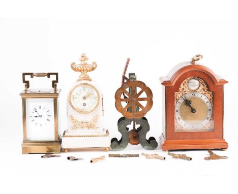 A French gilt brass four-glass carriage clock with repeating movement, 17.5 cm high, the enamel dial bearing Roman numerals, 