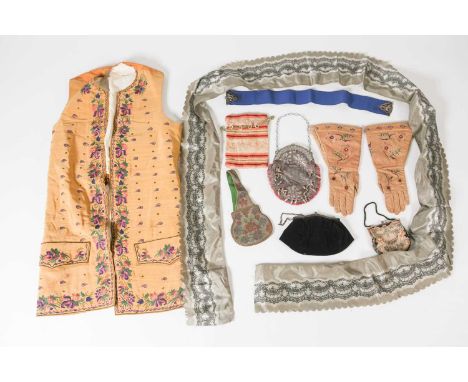 Of theatrical costume interest, a mid-century silk and embroidered long waistcoat, 100 cm long, together with a pair of embro