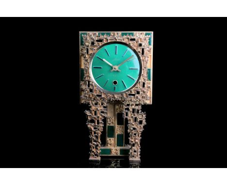 An Italian Modernist style desk clock, with green enamel dial bearing baton numerals, German 8-day movement, the gilt frame i