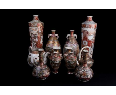 A Japanese Meiji period Satsuma globular vase with applied elephant head handles. Painted with a procession of geisher and sa