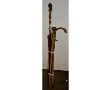 Two silver topped walking canes; a bamboo sword stick, circa 1900; and five other sticks (8)