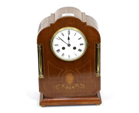 An Edwardian mahogany inlaid striking mantle clock