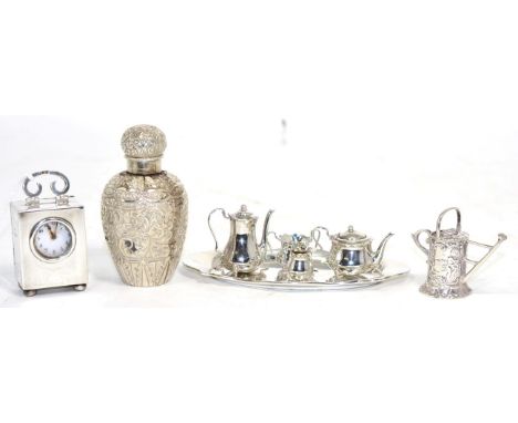 A Victorian silver bottle and cover Birmingham 1887, with scrolling foliate decoration; a miniature tea service and tray, Bir