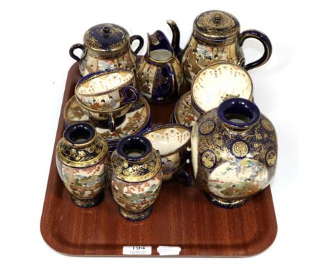 An early 20th century Japanese satsuma tea service together with a pair of matching vases and a further larger vase 