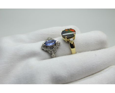 A Modern Dress Ring, marquise set to the centre, between pierced textured shoulders and textured shank, stamped "585", (finge