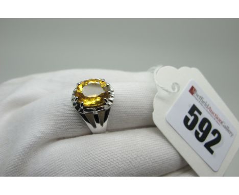 A Modern 9ct White Gold Single Stone Dress Ring, oval claw set between trifurcated shoulders, with Gems TV Certificate of Aut