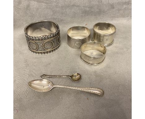 A collection of sterling silver items to include a buckle bracelet, napkin ring and other items 