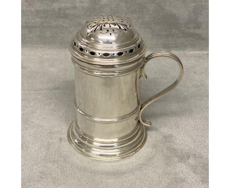 A sterling silver sugar shaker of pillar form with loop handle, Sheffield 1934 by Thomas Bradbury &amp; Son, 178g.&nbsp; 10.3