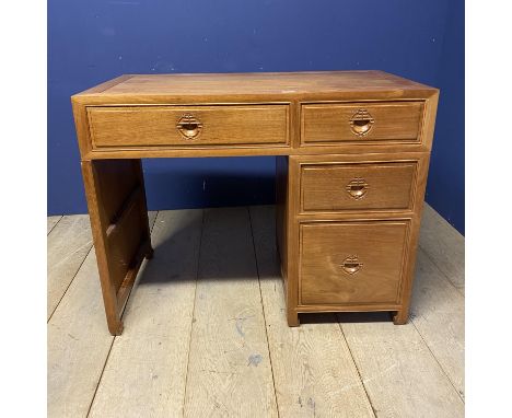 A light honey coloured desk desk, with 3 side drawers, and one central drawer,  in the oriental taste (faded) (matching lots 