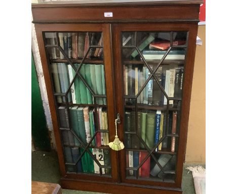 A mahogany and inlaid, astragal glazed bookcase, complete with vintage books of mixed titles, Geological interest, English Co