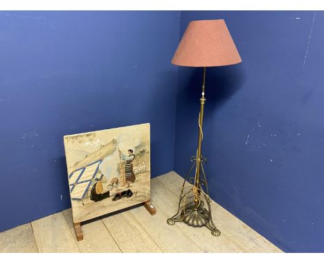 Brass standard lamp with pink shade,  and an oak framed fire guard with tapestry panel of biblical scene 