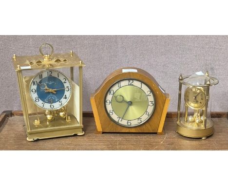 A New Master gilt metal 100-day mantel clock, an Art Deco walnut mantel clock and a West German Metamec anniversary clock