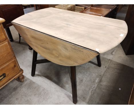 An Ercol Golden Dawn elm drop leaf table 