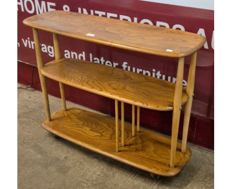 An Ercol Blonde elm and beech 361 model Giraffe bookcase/trolley 