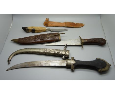 An Eastern dagger with scabbard, one with hoof handle and scabbard and one other dagger 