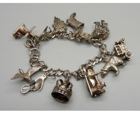 A silver charm bracelet, one charm set with an opal, 61g 