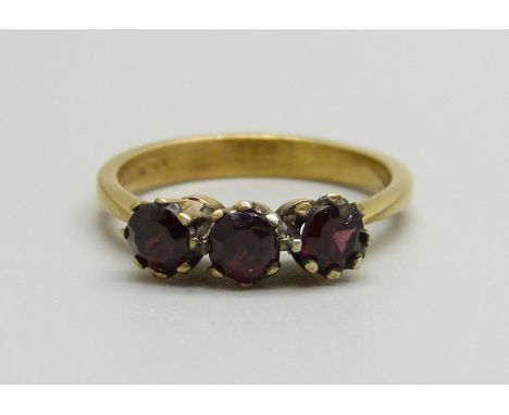 A silver gilt and garnet three stone ring, M 