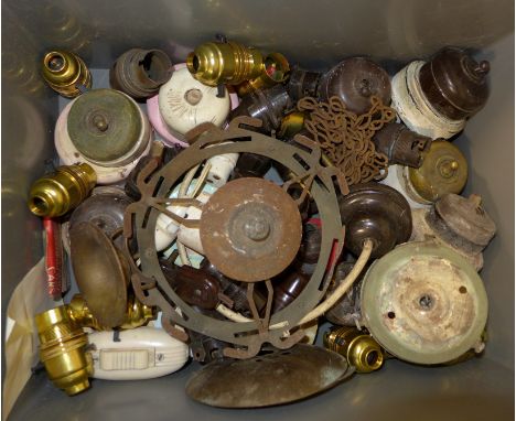 A collection of Bakelite and brass light switches, plugs and lamp fittings 