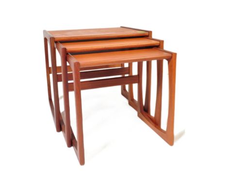 G Plan - Quadrille pattern - A 1970's retro vintage teak wood graduating nest of tables. The three nesting coffee tables havi